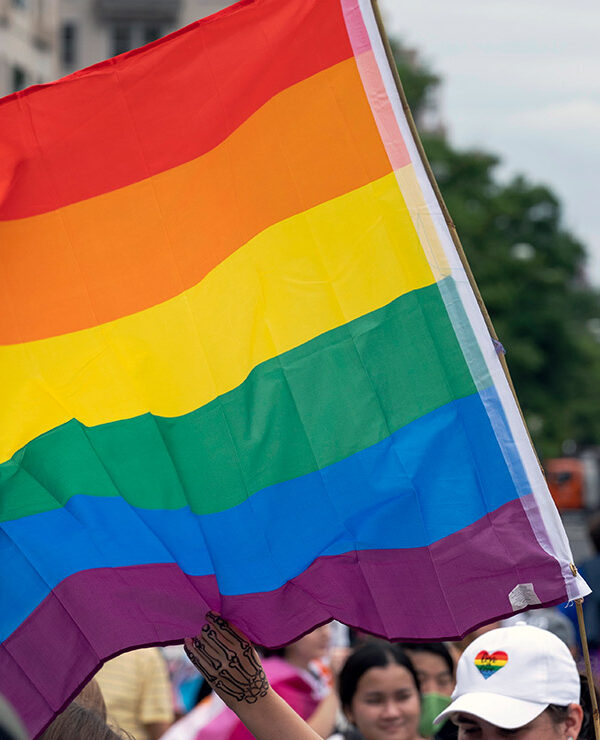 A rainbow flag with the U.S. capitol in the background.
