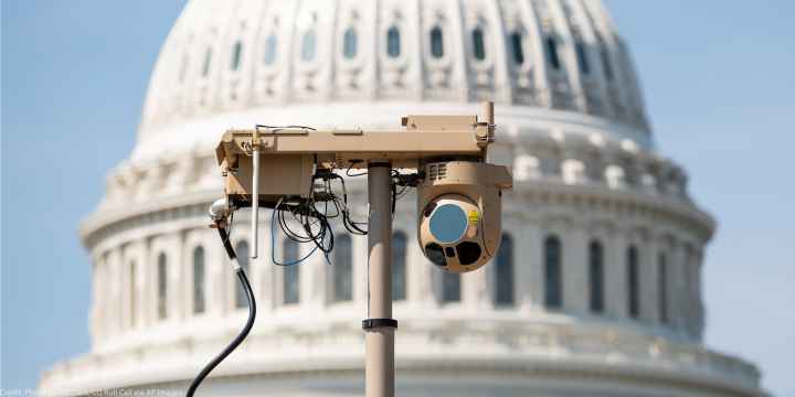 A close-up of a video surveillance unit set up in front of the U.S. Capitol building.